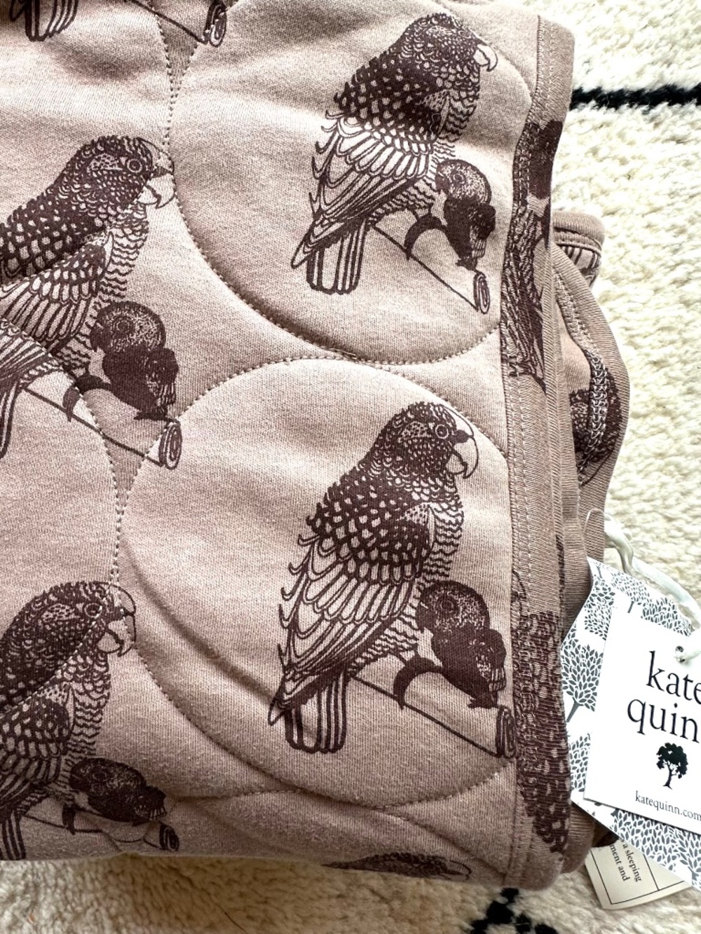 Kate Quinn baby floor quilt with a parrot pattern